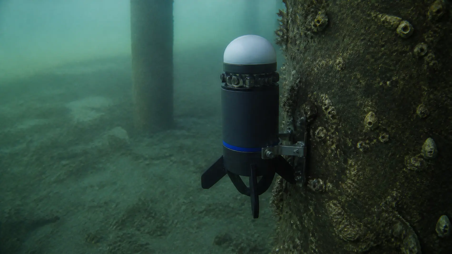 An underwater node mounted near industrial infrastructure